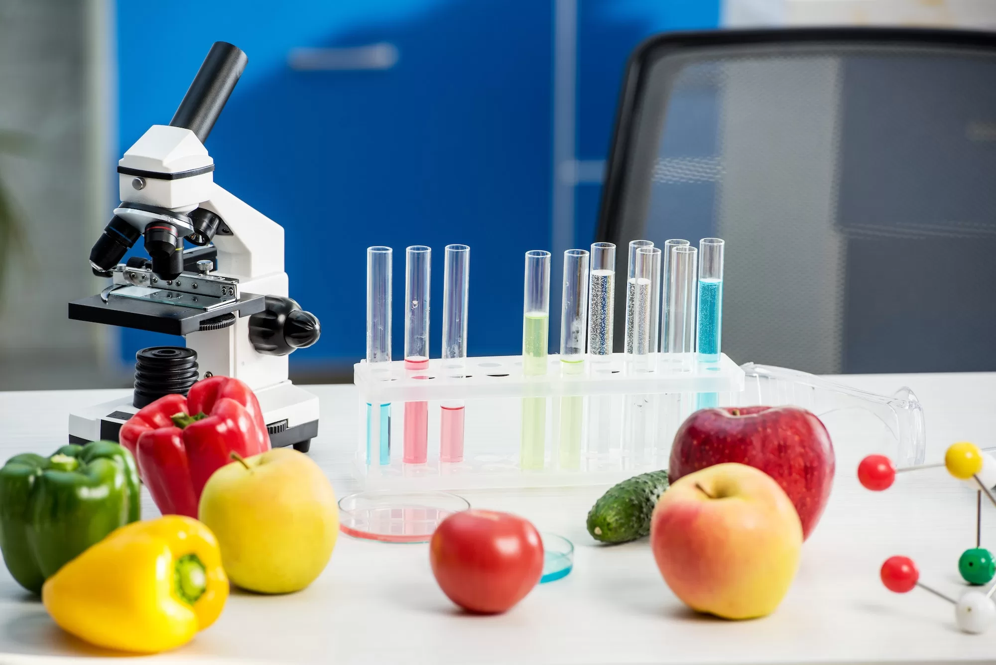microscope, fruit, vegetables, test tubes on table in lab